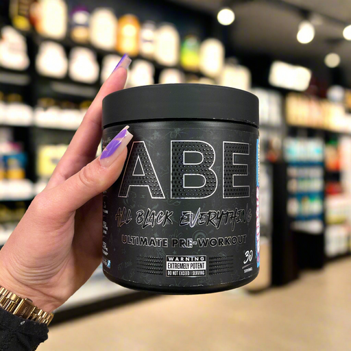 Close-up of (Applied Nutrition ABE Ultimate Preworkout 315g) held up inside My Supplement Shop, clearly showing the front label in a Sports Nutrition setting.
