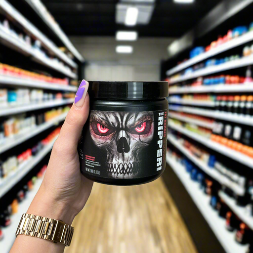 Close-up of (JNX Sports The Ripper! 150 grams) held up inside My Supplement Shop, clearly showing the front label in a Sports Nutrition setting.