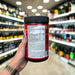 Close-up of (Mutant BCAA 9.7 with Micronized Amino Acid and Electrolyte Support Stack) held up inside My Supplement Shop, clearly showing key ingredients on the packaging in a Sports Nutrition setting.